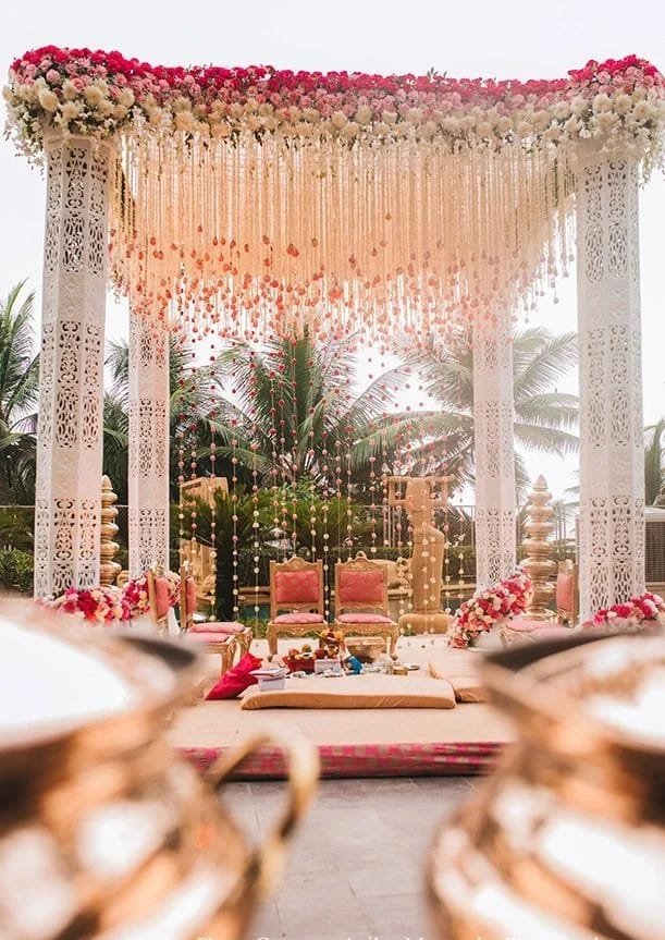 Exquisitely decorated mandap with floral arrangements and traditional elements