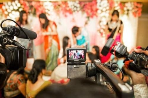 Professional wedding photographer capturing precious moments of the couple