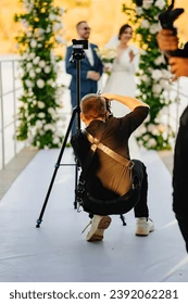 Professional wedding photographer capturing candid ceremony moments